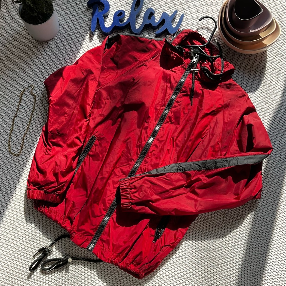 Red wind breaker jacket. Barely worn. Drawstrings attached.